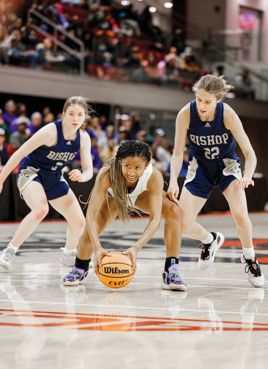 Chatham Charter senior Tamaya Walden (center) is swarmed by two Bishop McGuinness defenders in the Knights' 73-43 loss to the Villians on Saturday in the 1A state finals.